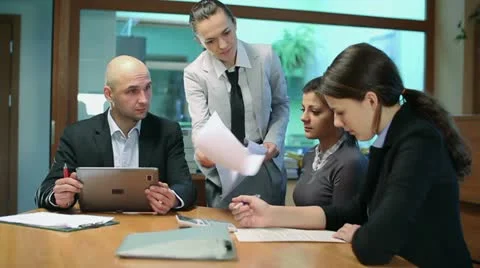 Female boss giving reprimand to her workers at business meeting, steadicam shot Stock Footage