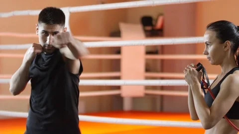 Female Boxer Exercising with Pull Rope during Workout with Trainer Stock Footage 111257967