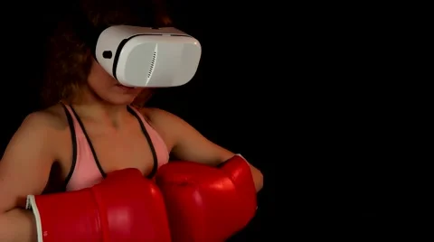 Female boxer fighting in virtual reality headset Stock Footage 62344160