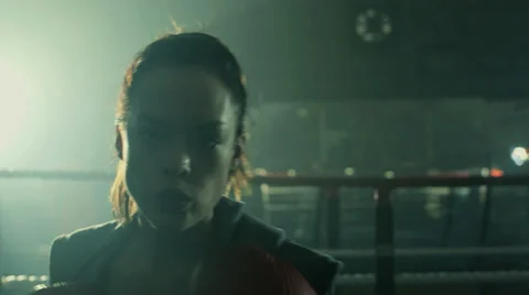 Female Boxer punches firecly inside the Boxing Ring Stock Footage
