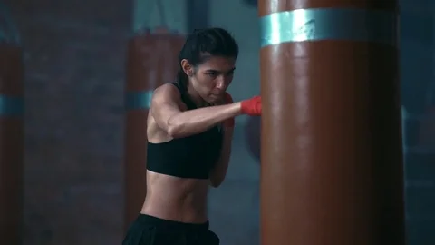 Female boxer training in boxing gym punching slow motion Stock Footage
