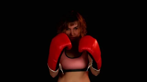 Female boxer training with red boxing gloves in studio on the black background Vídeos de archivo 62344433