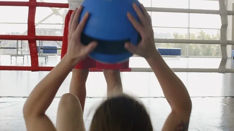 Female Boxers Doing Partner Sit Ups with Med Ball on Ring Stock Footage 119091932