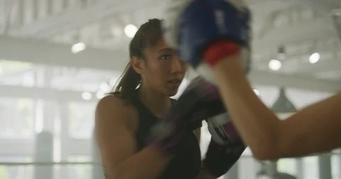 Female boxers practicing with mitts Stock Footage 99323802
