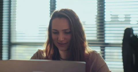 Female browsing internet, using laptop computer at home. Woman remote job from Stock Footage 254152258