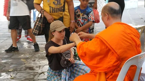 Female Buddhists receive blessing threads during Sonkran Festival Stock-Footage 106706772