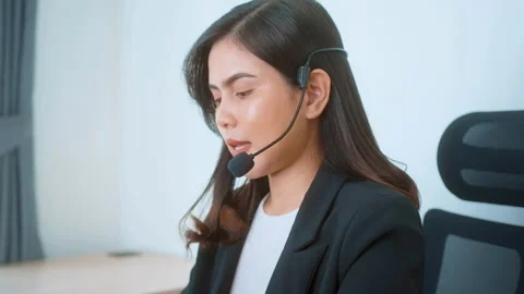Female call center agent with headset consulting clients online, customer ser Видео 205501552