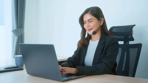 Female call center agent with headset consulting clients online, customer ser 動画素材 205501599