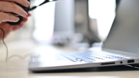 A female call center operator removes the headset and puts it on the laptop Stock Footage 135471753