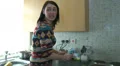 Female chatting as she makes tea HD Footage
