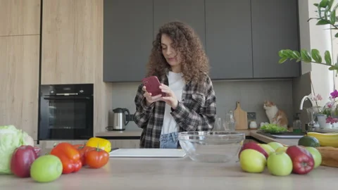 Female Checking Smartphone While Standing In Home Kitchen Video stock 318960929