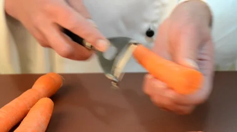 Female chef cleans  carrots Stock Footage 8829599