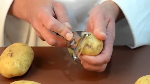 Female chef cleans potato Stock Footage 8829616
