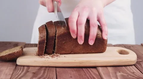 Female Chef Cut Black Bread on a Cutting Board. 動画素材 61839224