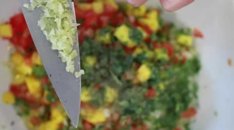 Female chef hands adding garlic to a delicious salad Stock Footage 45281192