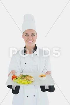 Female chef holding plate of healthyt meal Stock Photos