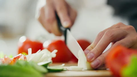 Female chef is preparing spring salad with tomatoes, cucumbers, onions, lett 動画素材 246743972