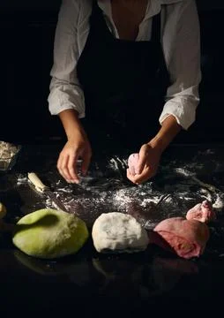 Female Chef Preparing Various Colored Pasta Dough in a Cozy Kitchen Setting Stock Photos