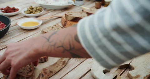 Female chef puts fried raw bread on a wooden table at the summer kitchen.Cook Stock Footage 144261024