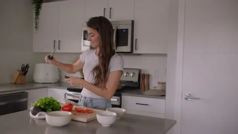 Female chef sharpening knife in kitchen Stock Footage 220753639