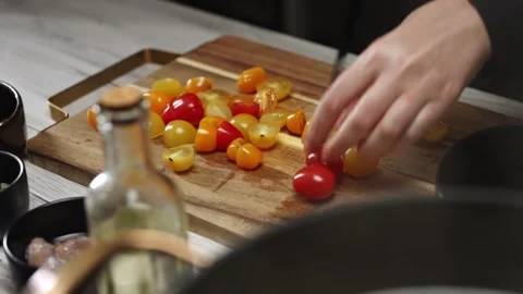 Female Chef Slicing Cherry Tomatoes with Sharp Knife. Stock Footage 309930426