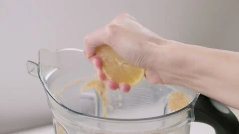 Female chef`s hand squeezing the lemon into the shaker bowl  Stock Footage 150305742