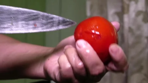 A female chef's hands cut a rose out of a tomato. Stock Footage 341765459