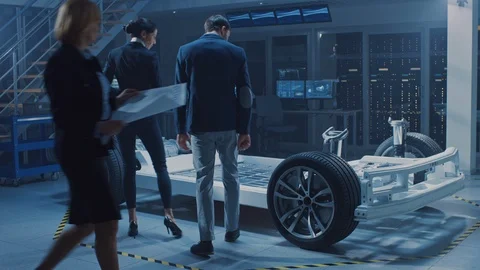 Female Chief Engineer Uses Tablet Computer, Discusses with investor Electric Car Video stock 106008503