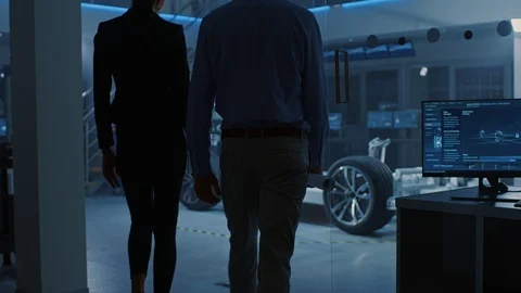 Female Chief Engineer Uses Tablet Computer, Discusses with investor Electric Car Video stock 106008740