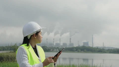 Female chief engineer working with laptop at coal plant in morning. Видео 223642799