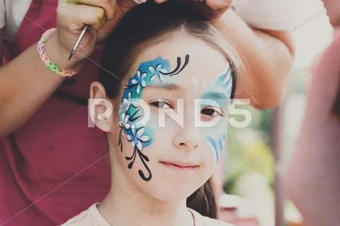 Female child face painting, making butterfly process Stock Photos
