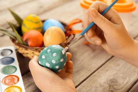 Female child paints Easter egg Stock Photos