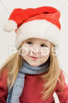 Female child with santa claus hat Stock Photos