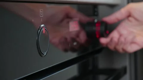 Female choosing program on electric oven panel Stock Footage 202672406
