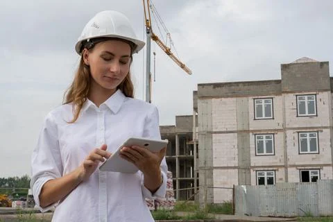 Female civil engineer using a tablet at her workplace on a construction site Stock Photos