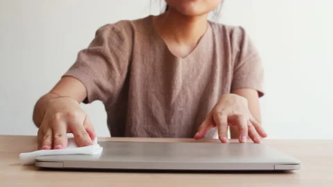 Female clean computer for hygiene when social distancing stay at home. Stock Footage 130340872