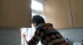 Female cleaning kitchen window HD Footage