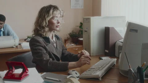 Female Clerical Working on Retro Computer and Inserting Floppy Disk Stock Footage 280264111
