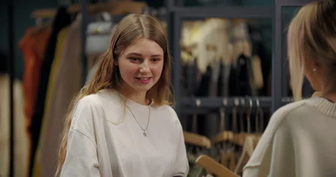 Female client responding to stylist during clothing consultation Stock Footage 321835708