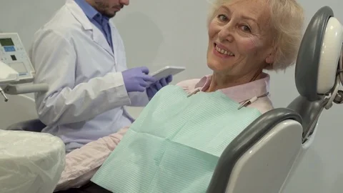 Female client shows her thumb up on the dental chair Video stock 73676305