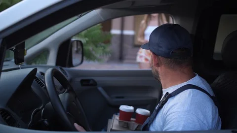 Female client taking coffee from delivery man Stock Footage 114972309