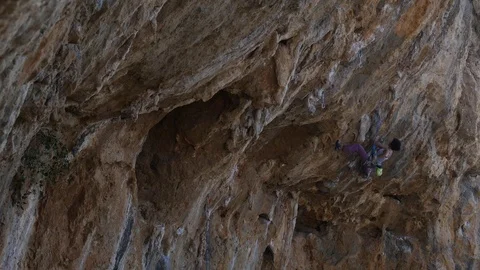 Female climber working hard on a extremely overhanging steep Stock Footage 70131731