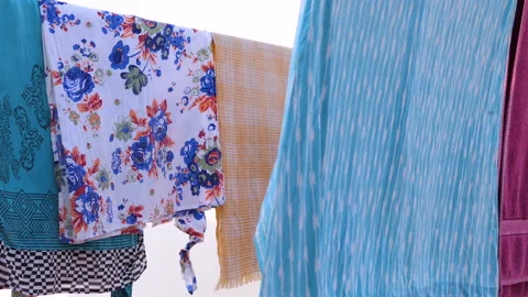 Female clothes laundry drying hanging on a rope to sun dry at the terrace Stock Footage 145645054