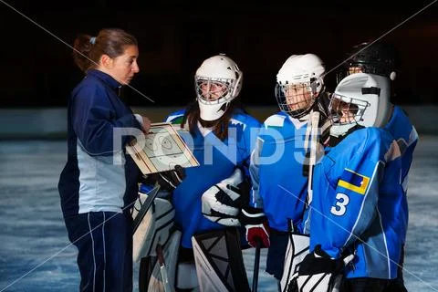 Female coach explaining game plan to hockey team Stock Photos