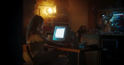 Female Coder Using Computer In Retro Garage At Night Stock Footage 256000519