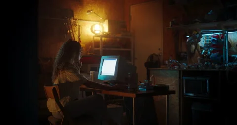 Female Coder Using Computer In Retro Garage At Night Stock Footage 256000566