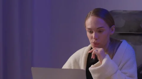 Female coder working. Female developer studying terminal output late at night Stock Footage 347879644