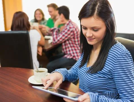 Female with coffee using tablet PC at  the coffee shop Stock Photos