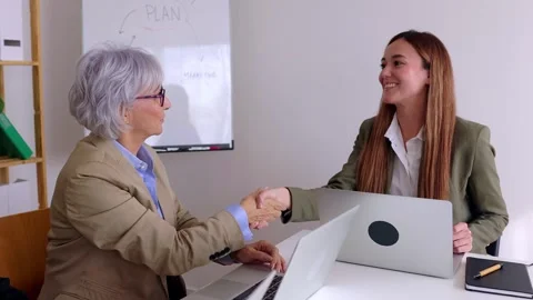 Female colleagues shacking hands in the office after business agreement. Stock Footage 270331815