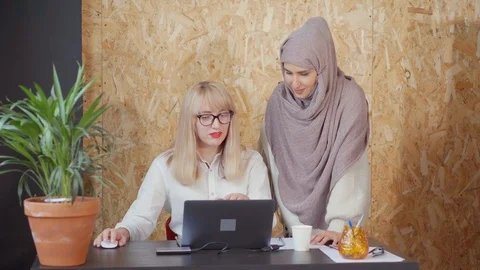 Female colleagues talking by the table. Stock Footage 107735682
